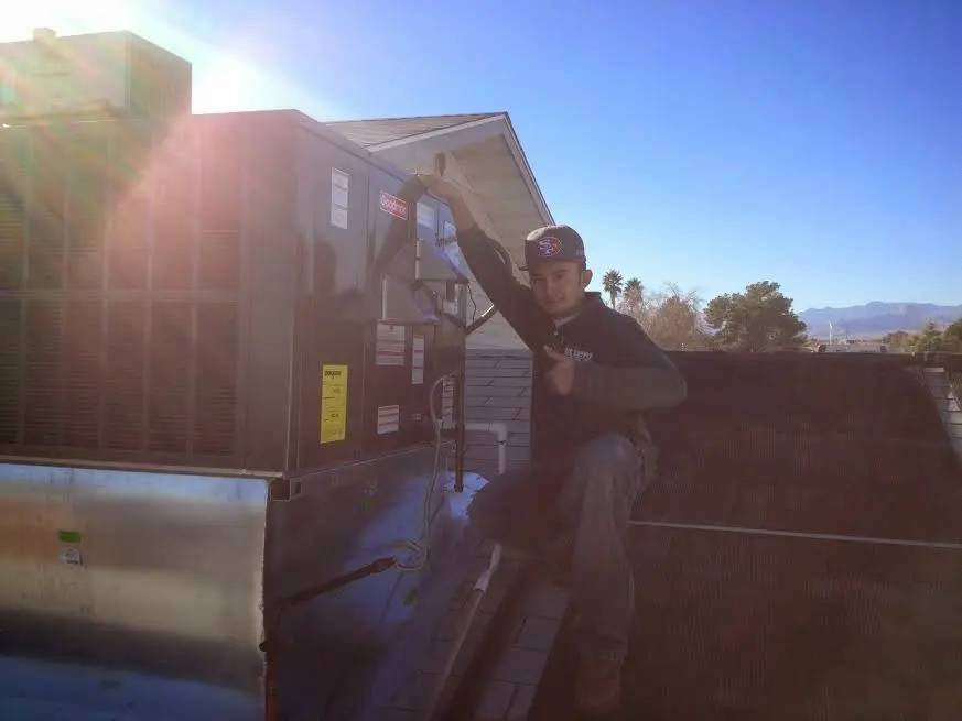HVAC technician performing Boiler Repair on a rooftop unit in Camden